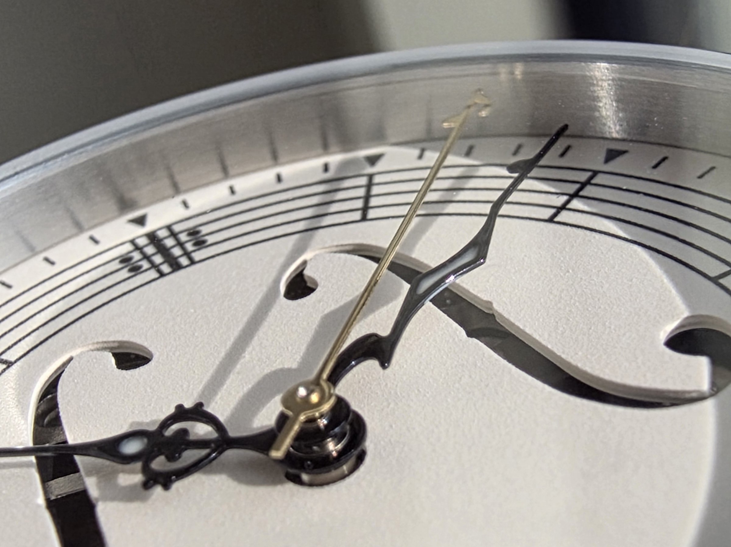 The dial forms a piece of sheet music with a circular staff…