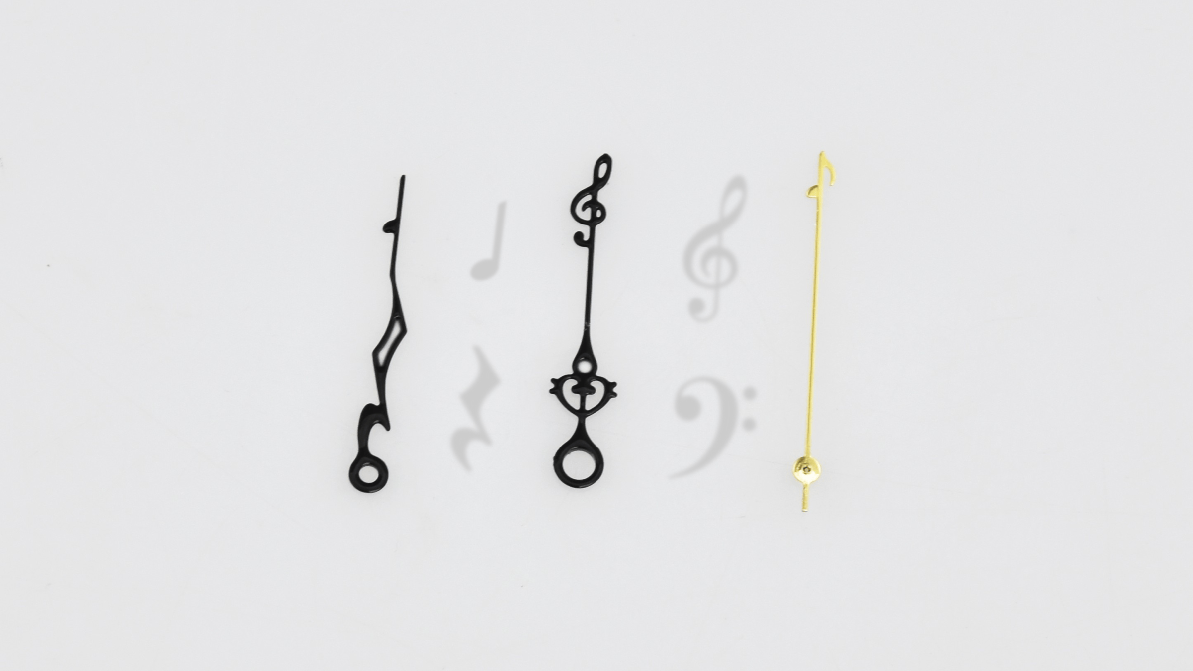 The brass hands contain the shapes of musical elements such as notes,…