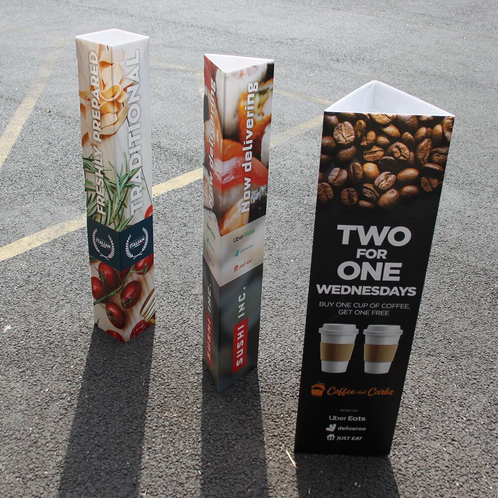 Printed bollard covers in triangle and square profiles — 4mm fluted board, 800, 1000 and 1200mm tall, for 100–250mm bollards, from £13 ex VAT